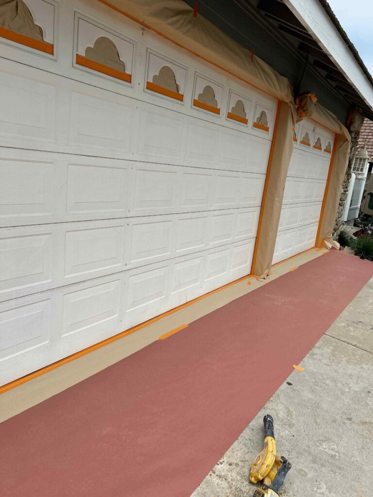 Freshly painted garage door with a smooth, modern finish in a neutral color – enhanced curb appeal and updated home exterior design