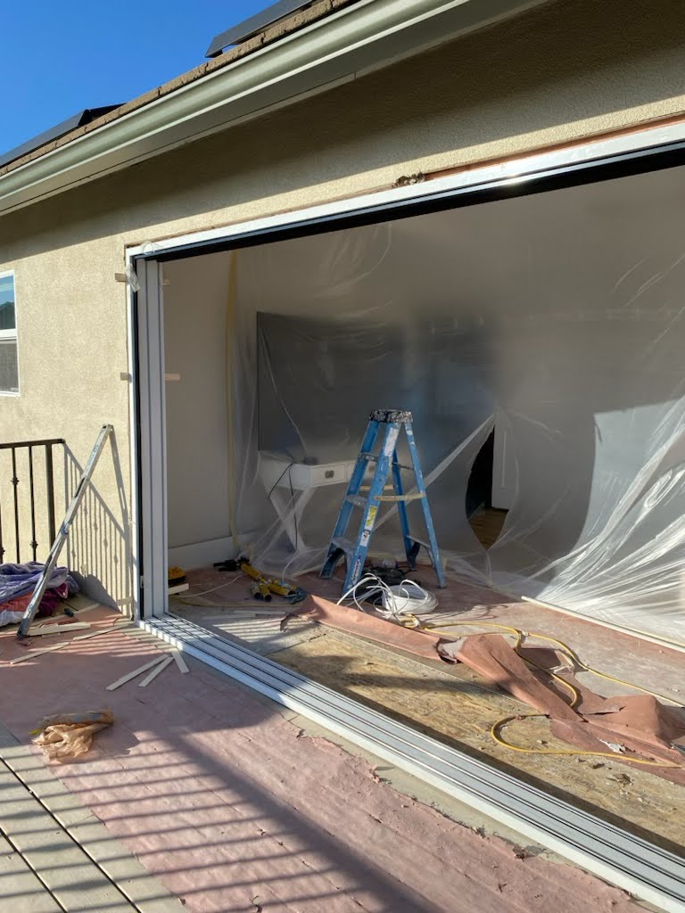 Garage interior with a paint job in progress, featuring partially painted walls and a clean workspace – transforming the space with a fresh coat of paint